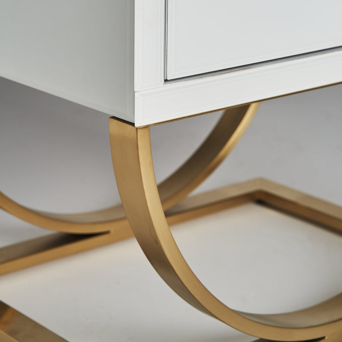 The Grabner Bedside Table in white and gold color embodies the opulence of Art Deco design. Crafted with a combination of steel and crystal, this exquisite piece exudes elegance and sophistication