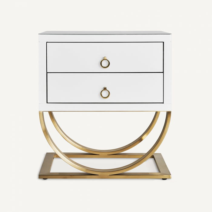 The Grabner Bedside Table in white and gold color embodies the opulence of Art Deco design. Crafted with a combination of steel and crystal, this exquisite piece exudes elegance and sophistication