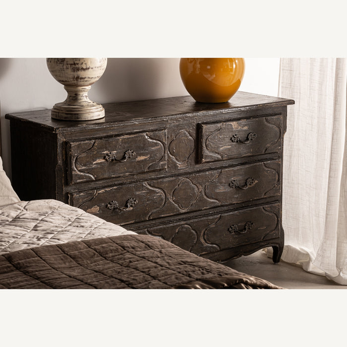 Breteuil chest of drawers, featuring a harmonious blend of black and natural shades, emanates the timeless elegance of classic design. Crafted meticulously from rich mango wood, its durability is accentuated with iron detailing, offering both strength and sophistication