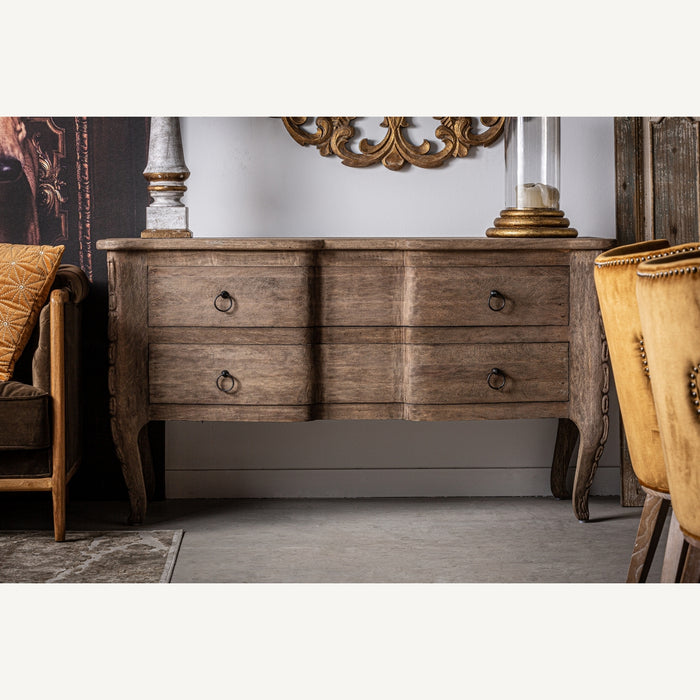 Moyaux sideboard, in a soothing natural shade, effortlessly channels the enduring charm of colonial design. Expertly crafted from solid mango wood, its intrinsic grain patterns and warmth are complemented by sturdy iron accents, offering a seamless blend of materials