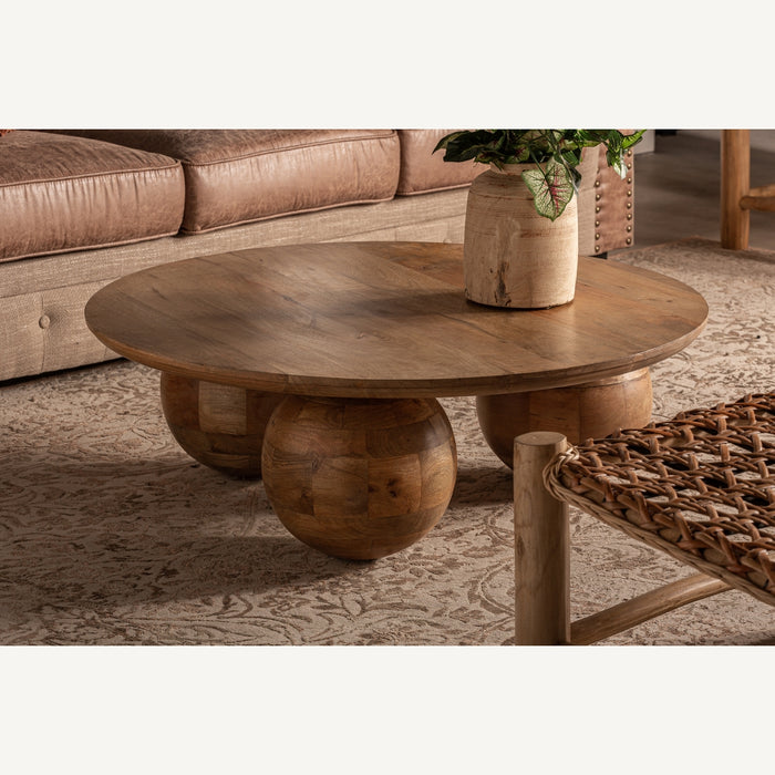 Bocksberg Coffee Table in natural brown color showcases a contemporary design that combines simplicity and functionality. Crafted from mango wood, this table offers both durability and a warm, natural aesthetic