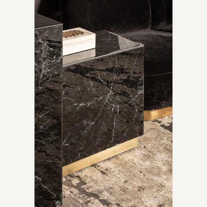 Introducing the Neva Side Table, a captivating addition to your interior design. With its sleek Art Deco style, this side table exudes elegance and sophistication. The combination of black and gold colors adds a touch of glamour to any room