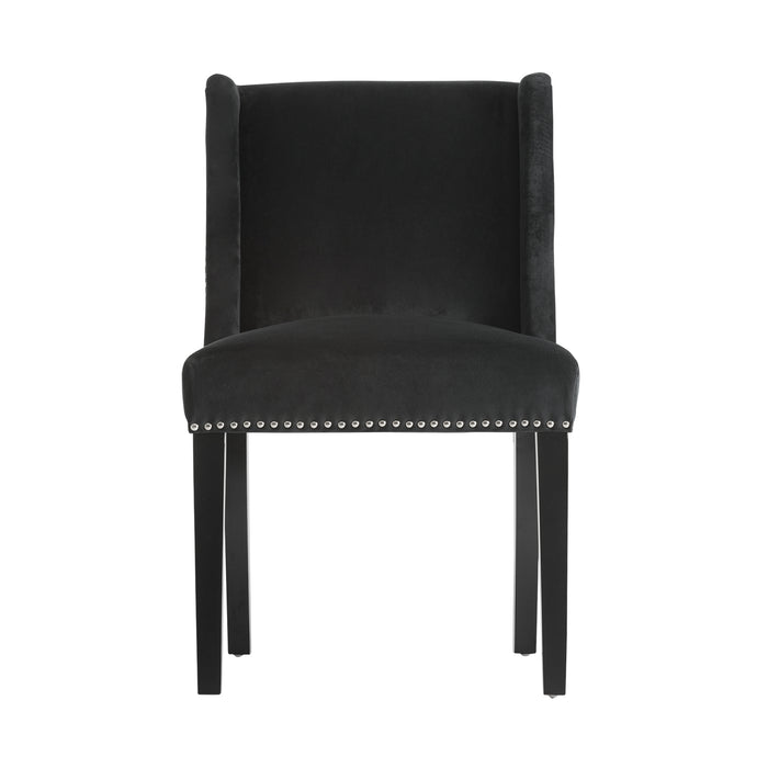 The Plaue chair, in a deep black shade, radiates the timeless sophistication of classic design. Constructed from resilient pine wood and enveloped in plush velvet with a cushioned foam layer, it ensures an opulent seating experience