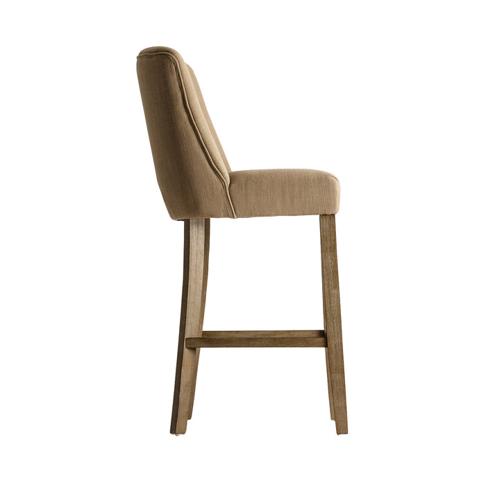 Aspach Stool, in a serene sand shade, exudes the timeless grace of classic design. Meticulously crafted from durable pine wood, it boasts a comfortable seat cushioned with foam and wrapped in premium polyester