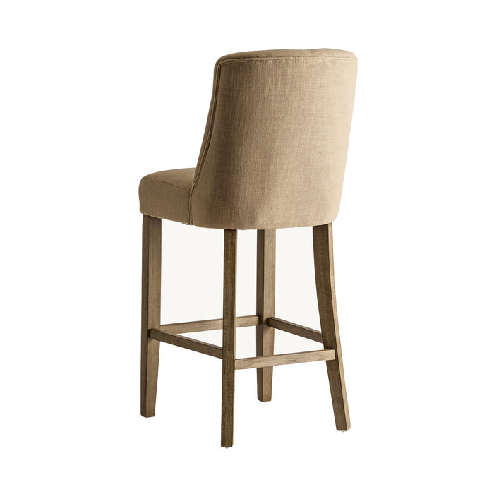 Aspach Stool, in a serene sand shade, exudes the timeless grace of classic design. Meticulously crafted from durable pine wood, it boasts a comfortable seat cushioned with foam and wrapped in premium polyester