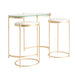 Enhance your living space with the glamorous Side Table Kruth (Set of 3) in a luxurious gold color. This Art Deco-inspired collection features meticulously crafted pieces made of iron, glass, and marble, creating a stunning blend of materials