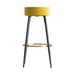 Carpi Stool, in contrasting mustard and black hues, takes a playful nod to the quirky Kitsh aesthetic. It's artfully upholstered in rich velvet, set atop a robust foundation of MDF and iron. Beyond its style, it's thoughtfully constructed to be easily disassembled, adding to its practical appeal