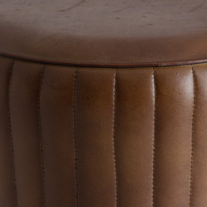 Stool Seney radiates a rich brown tone, capturing the timeless allure of vintage style. Constructed from sturdy iron, its seating is adorned with supple goat leather for added elegance. The fusion of materials delivers both durability and a classic aesthetic
