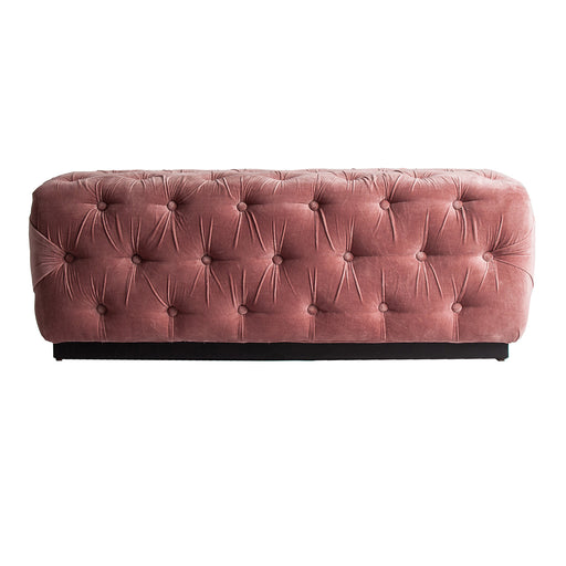 The Tardiano bed foot stool, in a delicate pale pink hue, perfectly embodies the whimsical charm of the shabby chic aesthetic. Expertly carved from mango wood and enveloped in plush velvet cushioned with foam, it promises both comfort and aesthetic appea