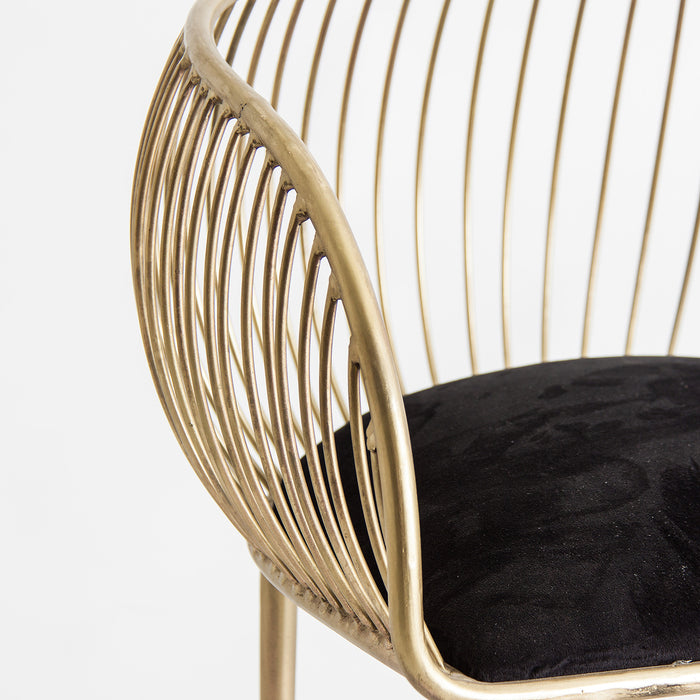 Introducing the Zug Armchair, a captivating piece that exudes Art Deco style and luxurious charm. With its striking black and gold color combination, it adds a touch of elegance to any space