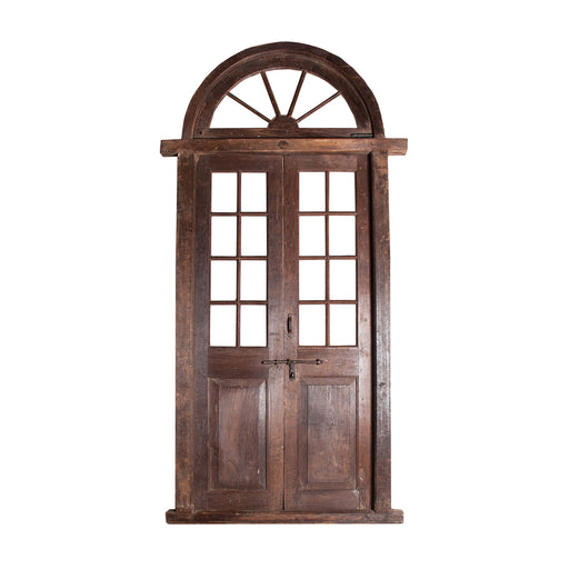 The DARIALEA Door is a stunning, hand-crafted piece that combines Ethnic Style with modern elegance. Made of high-quality Teak Wood in a rich brown color, this door features a beautiful Glass insert that adds a touch of sophistication to the design