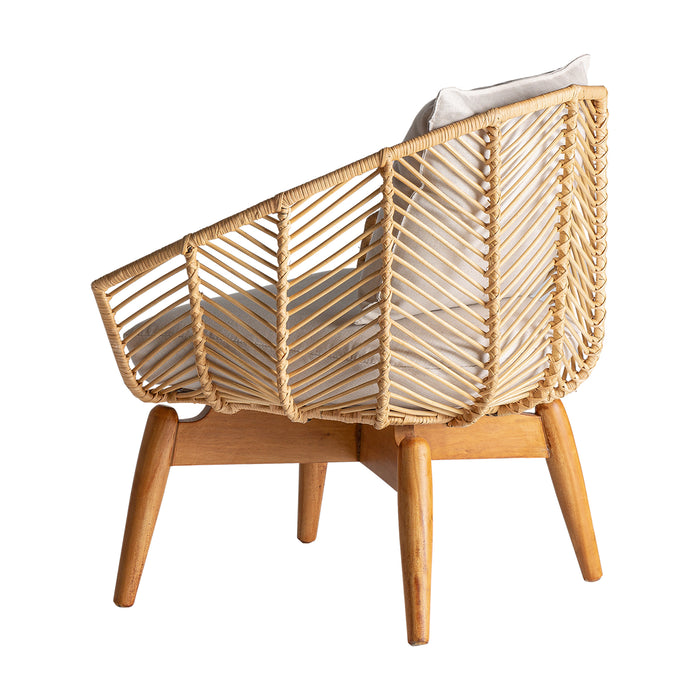 The Plissé Rattan Armchair features a natural-colored, Nordic-style design that combines Mahogany Wood with Rattan and Cotton materials