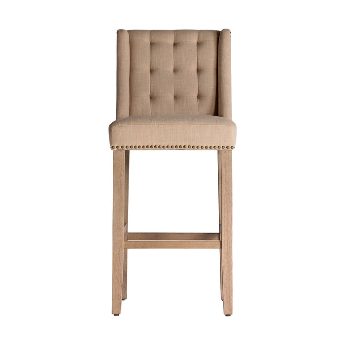 The Erfurt Stool, bathed in a subtle cream hue, channels the enduring elegance of colonial design. Carved meticulously from resilient pine wood, its seat is beautifully complemented by the earthy touch of canvas