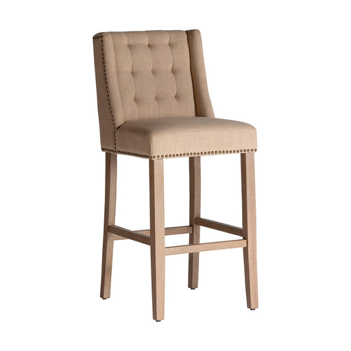 The Erfurt Stool, bathed in a subtle cream hue, channels the enduring elegance of colonial design. Carved meticulously from resilient pine wood, its seat is beautifully complemented by the earthy touch of canvas