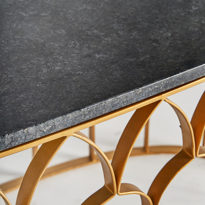 The luxurious Lauw coffee table is an Art Deco masterpiece, with an oval shape and a gold finish that exudes elegance. It is expertly crafted from iron and marble, making it a true statement piece in any room