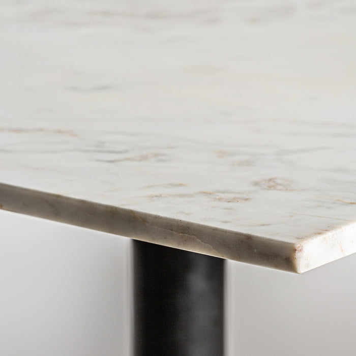 Harlem Bar Table, adorned in contrasting black and white shades, epitomizes the luxurious sophistication of Art Deco design. The table's opulent marble top rests gracefully upon a foundation of rich mango wood and resilient steel, offering a harmonious blend of materials