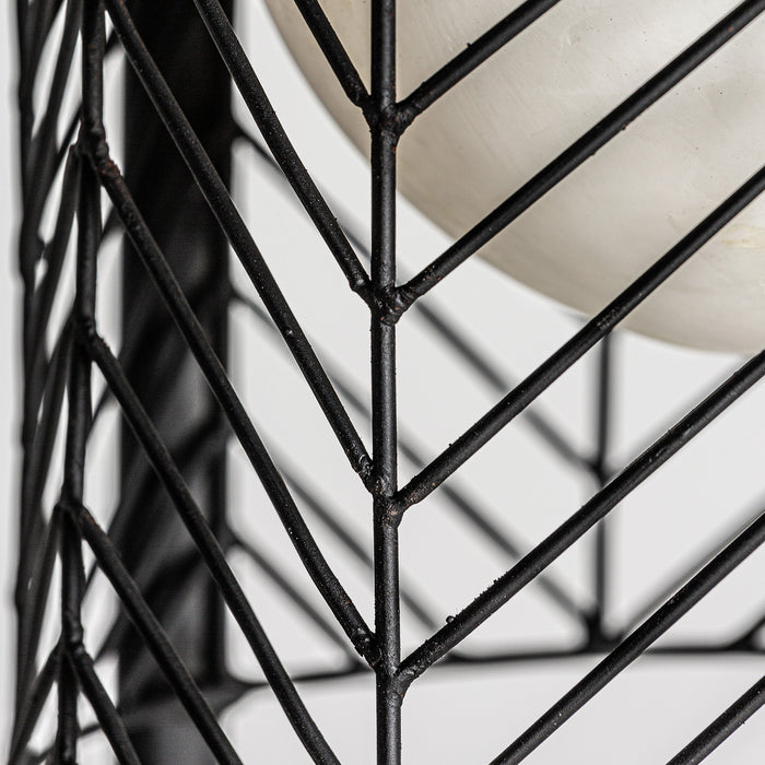 Plissé Metal Floor Lamp, radiating an Art Deco charm. Its striking black color effortlessly harmonizes with the sturdy concrete and iron construction, showcasing a captivating blend of materials