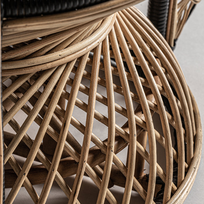 Introducing the Armchair DESOUK, a stunning statement piece that combines natural charm with contemporary design. The chair's intricate rattan weaving is complemented by the use of high-quality polyester, ensuring both comfort and durability