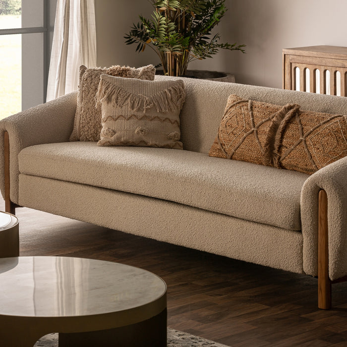 Colonial-style Prati Bouclé Sofa, constructed from a combination of oak wood, rubber wood, and pine wood, features a White & Natural color palette that enhances its aesthetic appeal